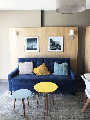 The living area is bright and cozy, perfect for relaxing after a day on the beach.