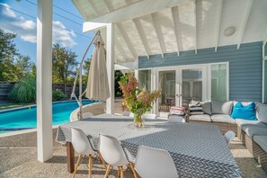 Outside patio with dining area, next to pool. Pool cover available upon request.