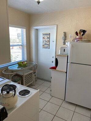 BRIGHT AND FULLY EQUIPPED KITCHEN ... DOOR LEADS TO PRIVATE PATIO SITTING AREA. 