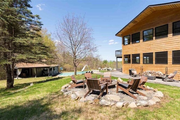 Fire pit with view of Pool and Pool House