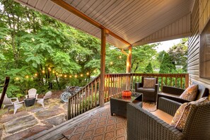 Relax on the covered porch or gather by the fire pit—this backyard is made for connection, comfort, and quiet evenings just minutes from shops, dining, and fun in downtown Blue Ridge.