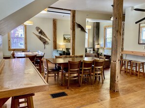 Dining area with 2 - eight person tables and breakfast bars.