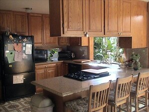 Updated Kitchen w serving counter is stocked with everything to cook/serve 36.