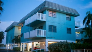 Complex exterior as you drive up. Unit in back, over bay. Parking under building