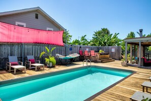 Another view of the pool, hot tub and covered patio