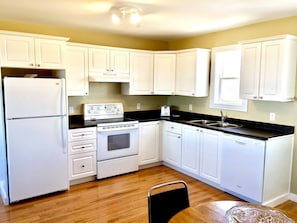 Bright, fully stocked kitchen