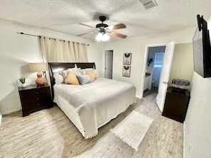 Large king bed in our master bedroom w/ private TV and attached bathroom