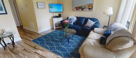 Pretty urnishings in beachy colors and leather sofas that are super comfy!  Smart TV for streaming.
