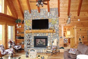 Main family room with beautiful stone fireplace and 60'' HD TV