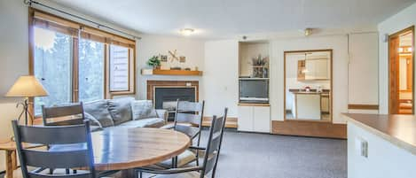 Open Floor Plan - Dining table and seating for four, queen sofa sleeper, queen murphy bed, and private balcony.