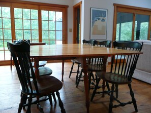 Dining table and view out rear sliding door. Screen porch is thru door on right