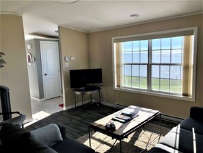 The Living Room with ocean view and  SMART TV with satellite cable