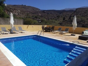 newly refurbed pool area with steps into pool, new sofas and sunbeds!