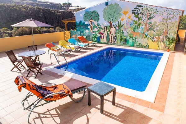 private Heated swimming pool on 100 sq m. terrace with dining table and seating.