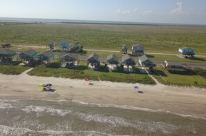 House is behind the red umbrella…..beach front