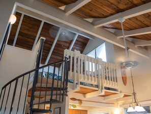 En suite loft with king bed and distant ocean view