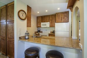 granite counter breakfast bar with custom cabinets