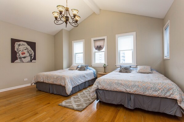 Spacious bedroom with two queen size beds and en-suite bathroom