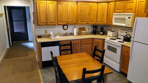 Locally made hardwood cherry cabinets with Corian countertop.