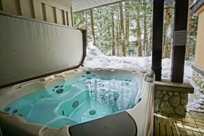 Private hot tub on the back patio for your exclusive use, facing the forest.