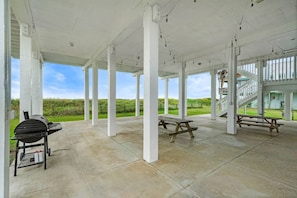 The covered outdoor patio has tons of space for family barbeques