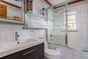 Full bathroom with abundant towels, toiletries