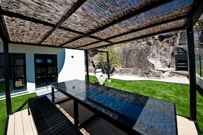 Inviting dining and barbecue area with garden and sea views