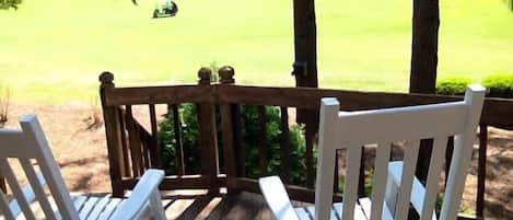 Watch golf from deck in classic Pinehurst white rocking chairs