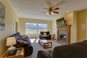 Living Room w/ a cozy fireplace and a view.