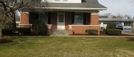 Front of home with large porch and key pad for easy entry