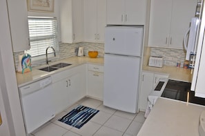 On the main level, the open and spacious kitchen is well-stocked ...