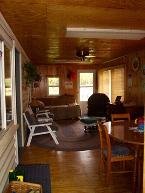 The enclosed front porch, with dining area.