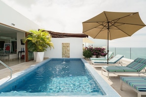 Heated private pool with panoramic ocean view on upper level terrace.