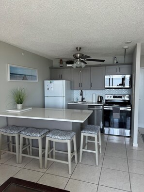 New kitchen in 2024 with updated cabinetry, counters, seating and appliances!