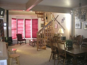 Dining room, circular stair to loft, fireplace beautiful views tasteful decor