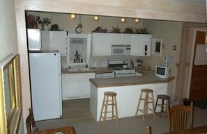 Kitchen with all cooking utensiles. new microwave, new dishwasher, new paint