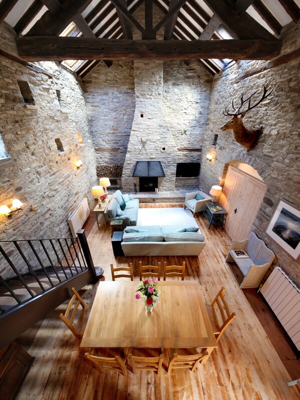Double height, open plan sitting room, dining room and kitchen.