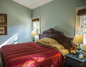 His and hers nightstands, lamps and windows.