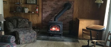 Nothing like a wood stove to warm you up!  leather recliner replaced plaid couch