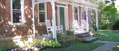 Relax on the front porch or enjoy the view of the wooded lot surrounding the Inn