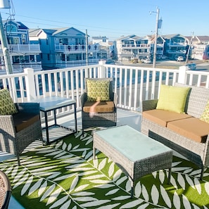 Living room has large deck with views of the bay and peek view of the ocean.
