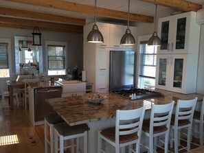 Gourmet kitchen with large dining room behind
