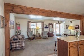 Living room provides seating for those not food prepping