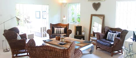 Open plan living area looking out to the secluded garden and plunge pool