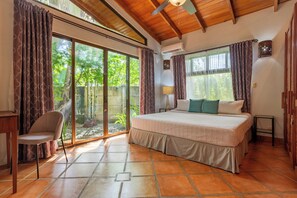 Bedroom #1 with comfy king bed, ac and sliders that open to the pool and garden.