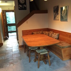 Banquette for dinning / Door open to outdoor hallway
