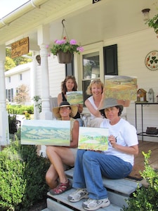 Artists display their work on front porch