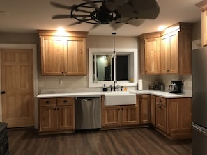 New kitchen with farmhouse sink and garbage disposal.