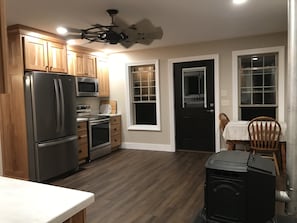 View of the newly renovated kitchen from the mid room entry