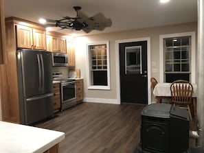 View of the newly renovated kitchen from the mid room entry 